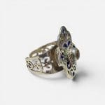 Beautiful Fatima ring with a reddish stone in the middle. Fine enamel details in yellow, green and blue. Silver carvings.