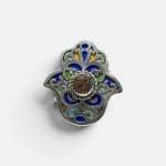 Beautiful Fatima ring with a reddish stone in the middle. Fine enamel details in yellow, green and blue. Silver carvings.
