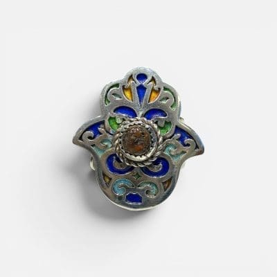 Beautiful Fatima ring with a reddish stone in the middle. Fine enamel details in yellow, green and blue. Silver carvings.
