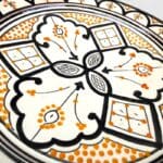 Black ceramic plate with yellow pattern handmade in Morocco. Measures 26 cm.