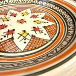Beautiful couscous dish in ceramic measuring 28 centimeters. Black with orange pattern, and handmade in Morocco.